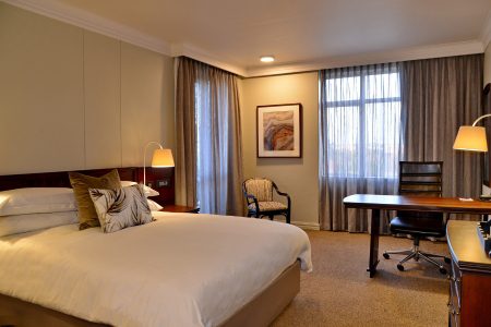 Hotel room with bed and office desk
